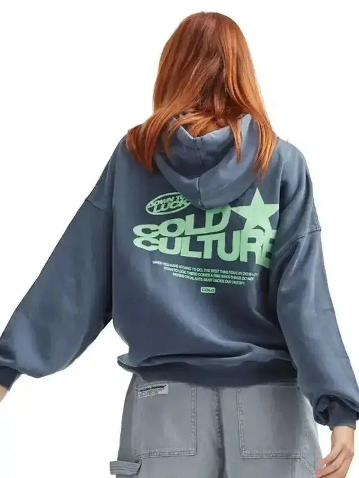Women's oversized graphic hoodie with bold print for streetwear & urban fashion. A trendy, comfortable casual top.