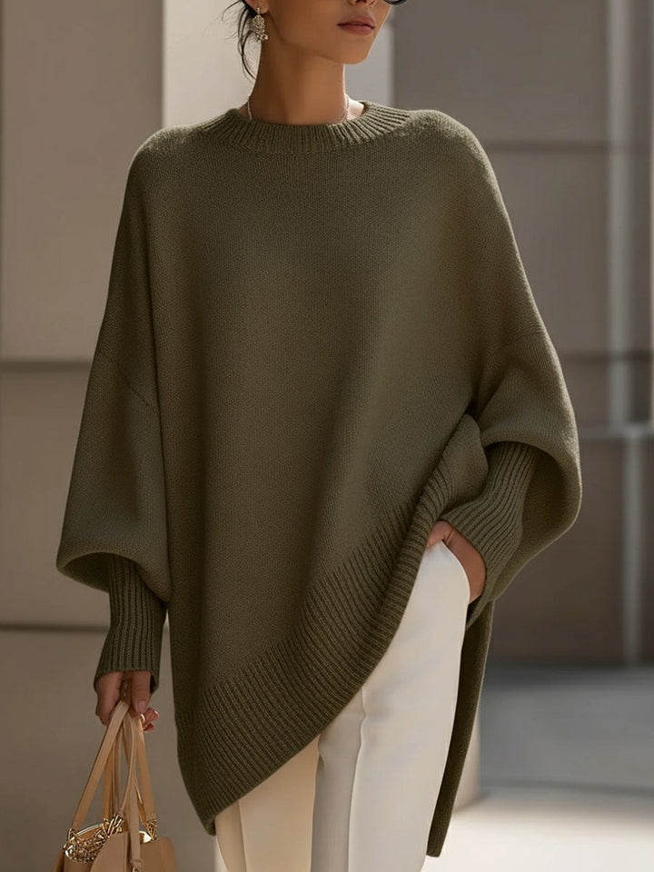 Modern women's long sleeve sweater, oversized knit. Effortless casual top with asymmetrical hem.