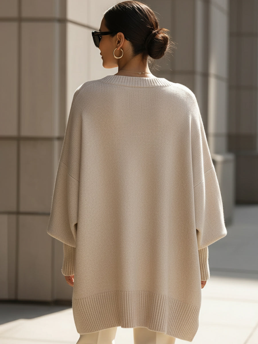 Modern women's oversized sweater, effortless style. Draped knit with asymmetrical hem.