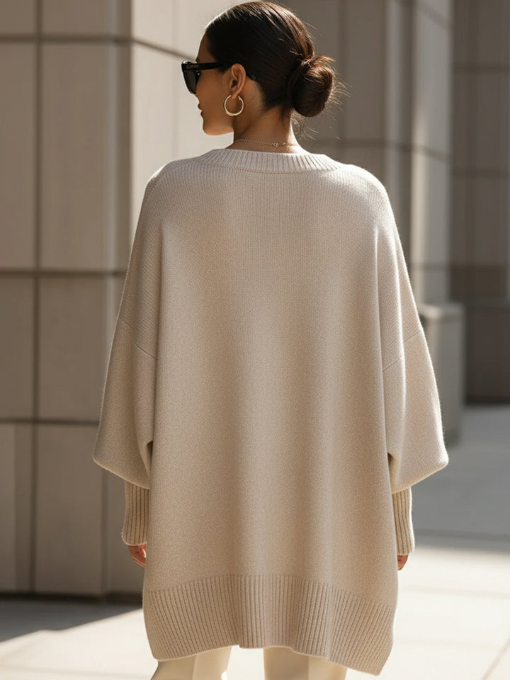 Modern women's oversized sweater, effortless style. Draped knit with asymmetrical hem.