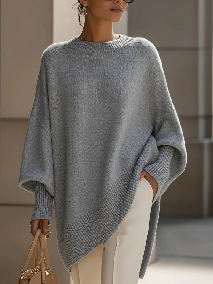 Draped oversized knit sweater for women, asymmetrical hem. Effortless long sleeve for cozy style.