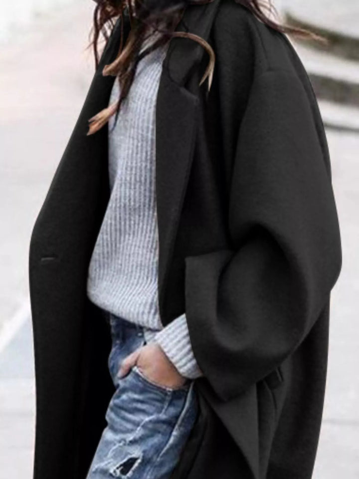 Fashionable women's oversized long coat, ideal for winter layering and chic cold-weather style.