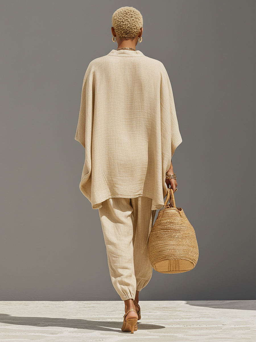 Comfortable women's set: oversized notched top & flattering tapered pants. Essential for a chic, relaxed casual outfit.