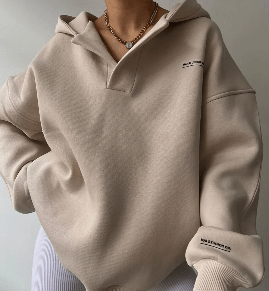 Women's oversized pullover hoodie with stylish notch neck and drop shoulder for casual comfort.
