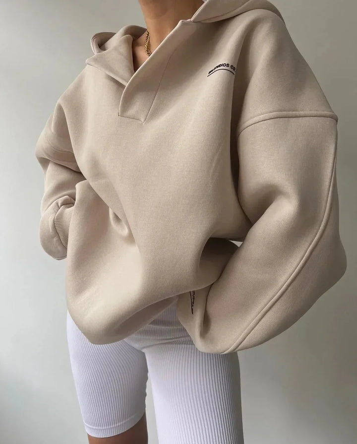 Trendy women's oversized pullover hoodie with a stylish notch neck and comfortable drop shoulder design.
