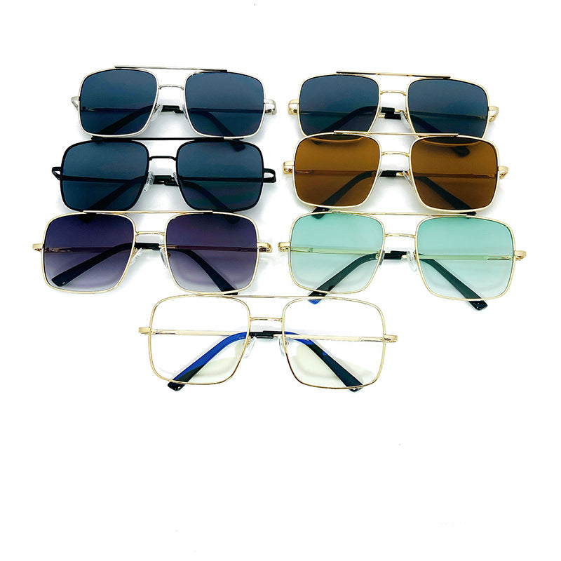 Stylish women's square sunglasses, oversized with a golden frame, for fashion and UV safety.