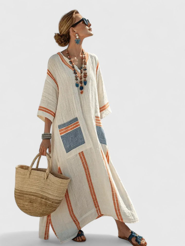 Flowy women's striped kaftan maxi dress. Ideal beachwear or resort wear, offering comfort and style.