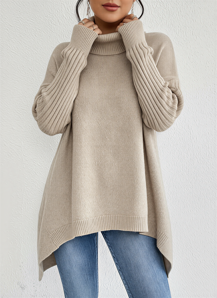 Stylish oversized turtleneck jumper for women, featuring an asymmetrical hem and ribbed sleeves.
