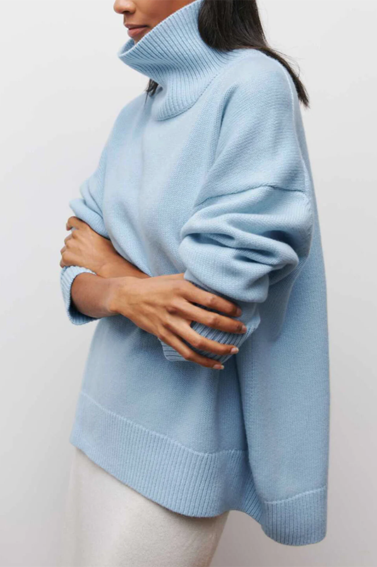 Comfortable women's oversized pullover sweater with a warm turtleneck, ideal for cozy winter fashion.