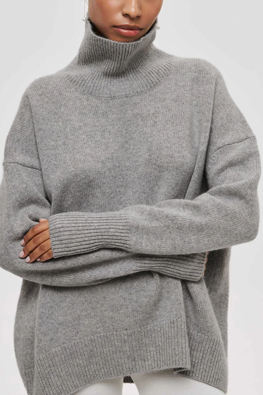 Warm women's oversized sweater with a high turtleneck, a stylish and cozy pullover for winter fashion.