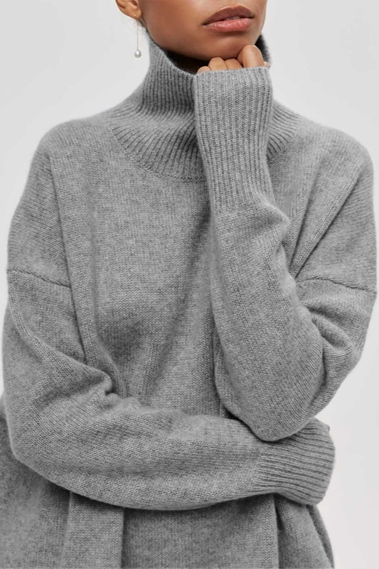 Fashionable women's oversized pullover sweater with a trendy turtleneck and comfortable drop shoulders.