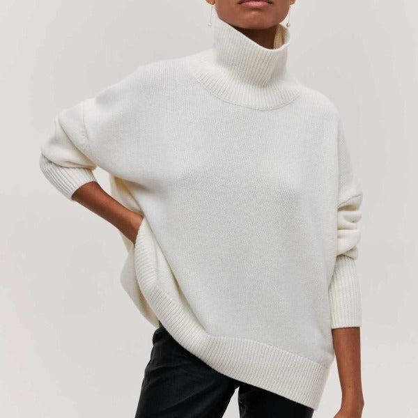 Women's oversized turtleneck sweater. Cozy knit jumper, relaxed fit long sleeve top for autumn and winter fashion.