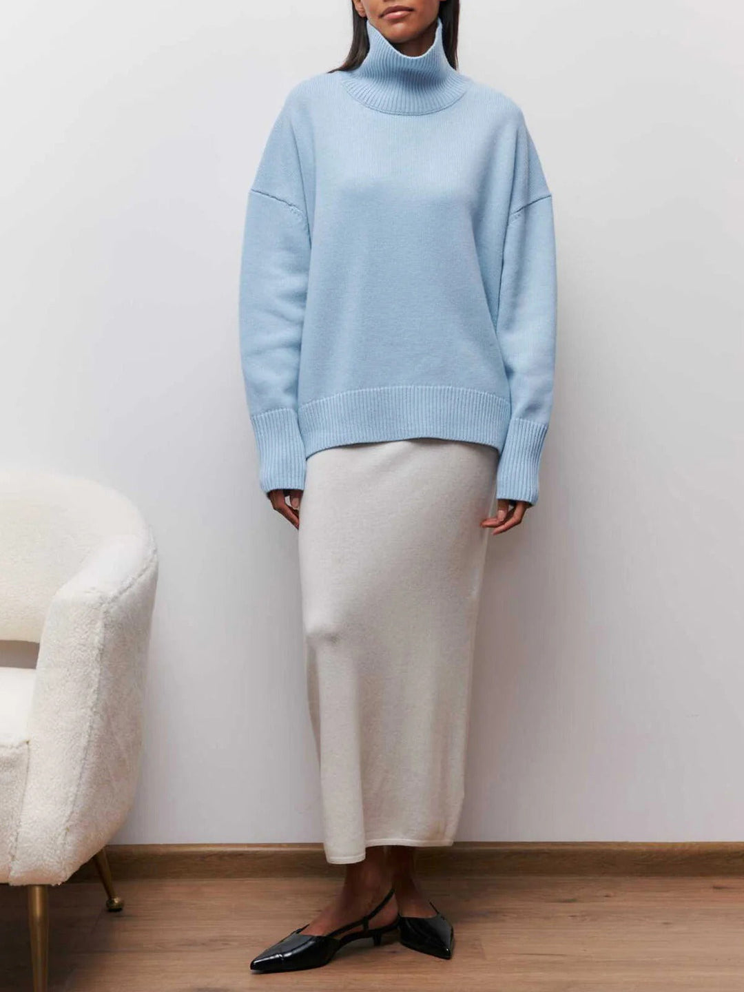 Soft, cozy knit oversized women's turtleneck pullover sweater, with modern elbow slits for everyday wear.