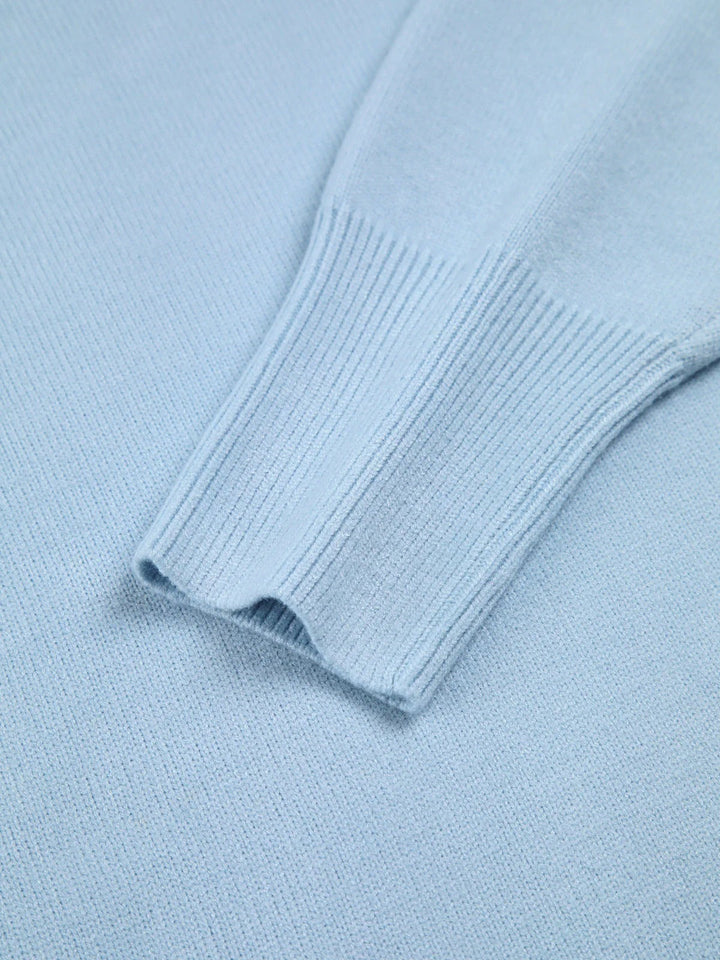 Stylish women's oversized turtleneck pullover, featuring unique elbow slits for a modern, cozy look.
