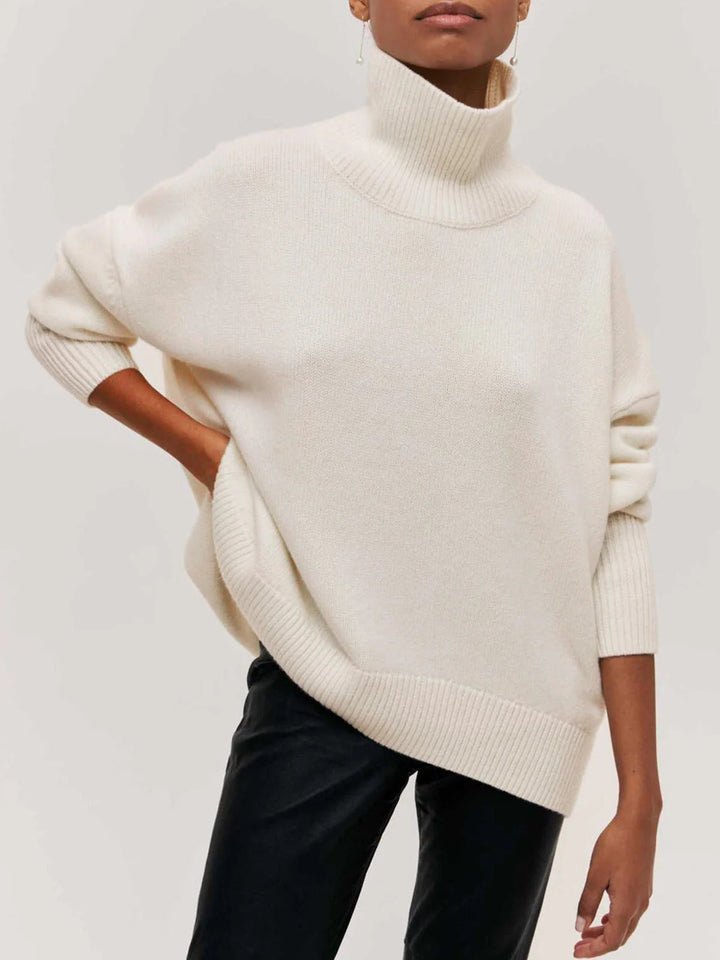 Versatile women's oversized turtleneck sweater with elbow slits, offering relaxed style for any occasion.