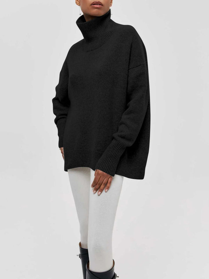 Plush, oversized women's turtleneck sweater with fashionable elbow slits, ideal for cozy chic styling.