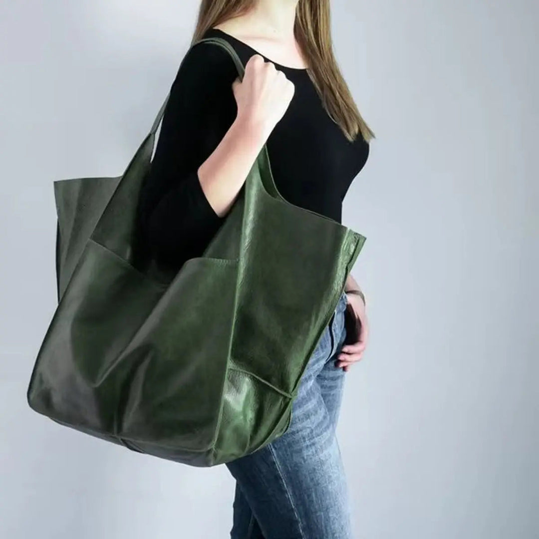 Women's oversized vegan leather tote bag with magnetic closure, ideal for everyday use.