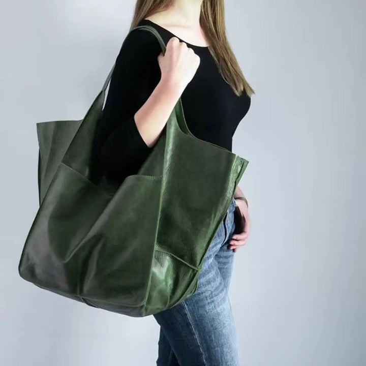 Women's oversized vegan leather tote bag with magnetic closure, ideal for everyday use.