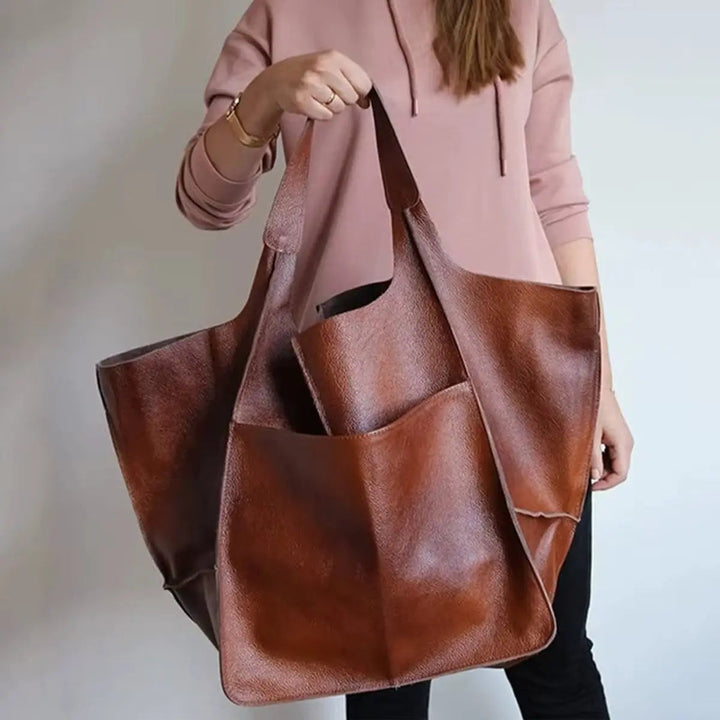 Elegant women's oversized vegan leather tote bag, magnetic closure, ideal as a fashion or work bag.