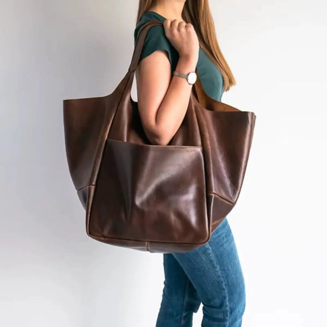 Fashionable oversized vegan leather tote for women, secure magnetic closure, an elegant shoulder bag.