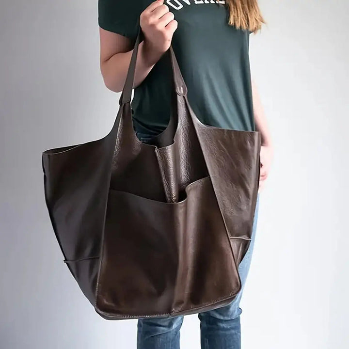 Versatile women's oversized vegan leather work bag & everyday tote, magnetic closure for security.