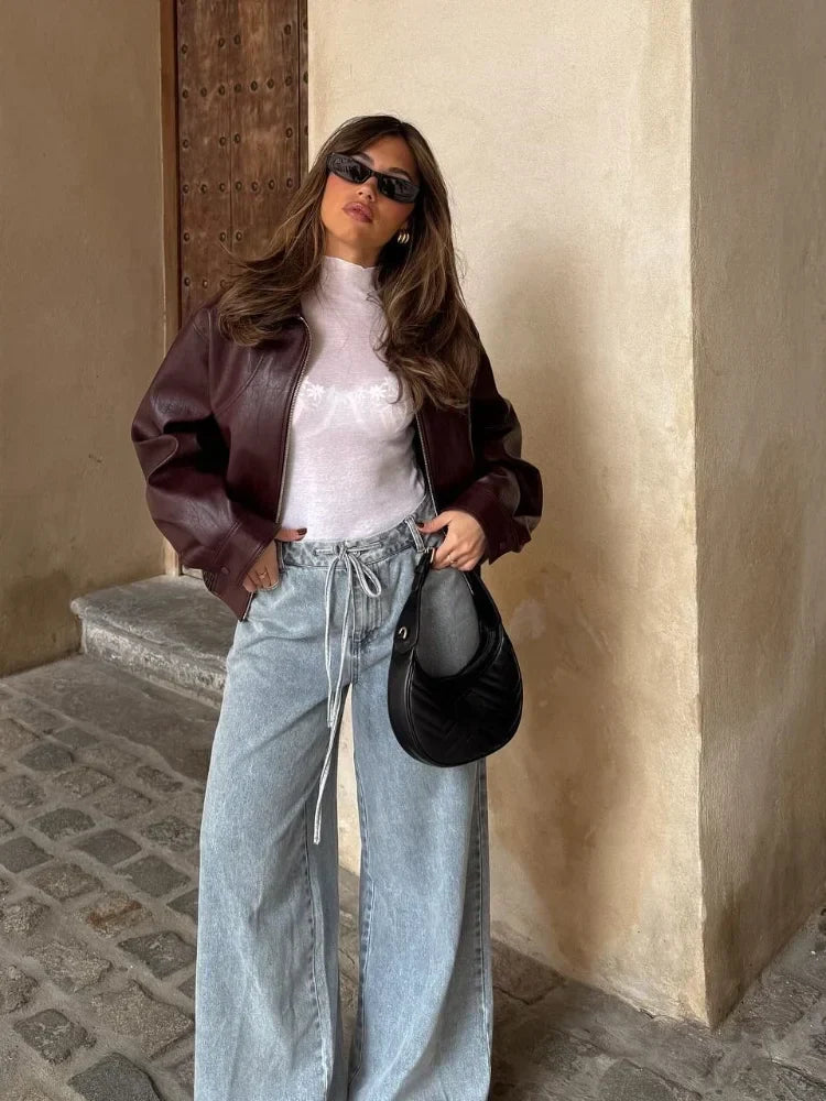 Stylish women's oversized waist-length leather jacket in winered, transitional outerwear for spring/autumn.