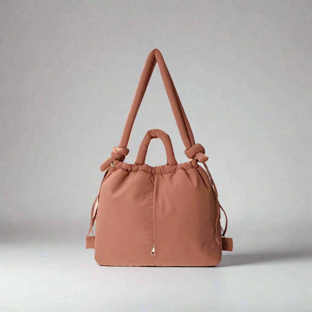 Women's padded drawstring tote bag for everyday use. Lightweight and stylish shoulder bag.