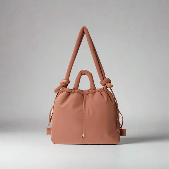 Women's padded drawstring tote bag for everyday use. Lightweight and stylish shoulder bag.