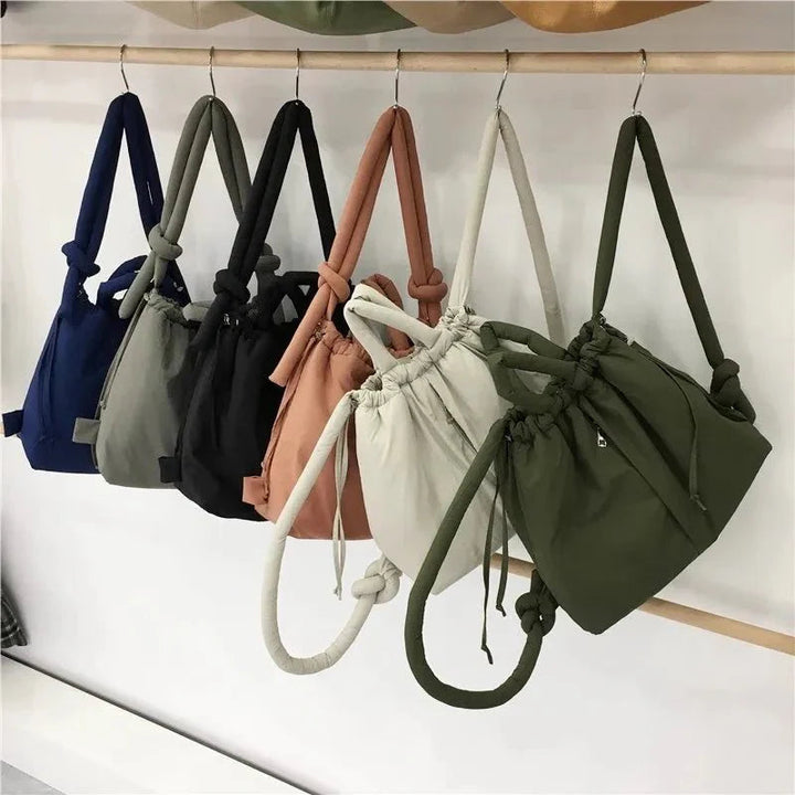 Padded women's tote bag. Drawstring closure, lightweight & chic for everyday use as a shoulder bag.