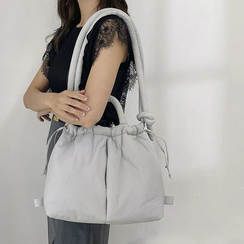 Women's lightweight padded tote bag. Drawstring closure for a chic, versatile everyday handbag.