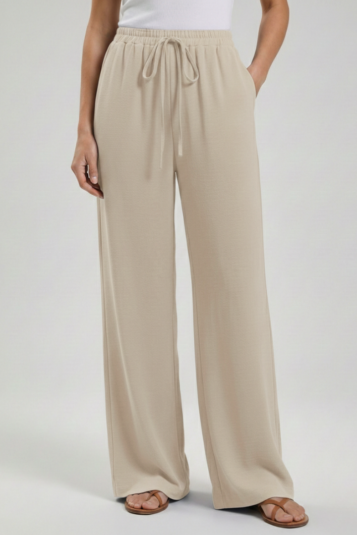 Elegant women's wide-leg palazzo trousers with a relaxed drawstring waist for casual comfort.