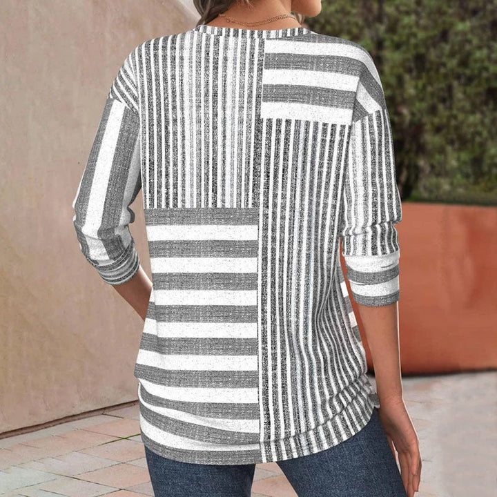 Relaxed fit grey women's blouse featuring a chic patchwork and striped design with comfortable 3/4 sleeves.