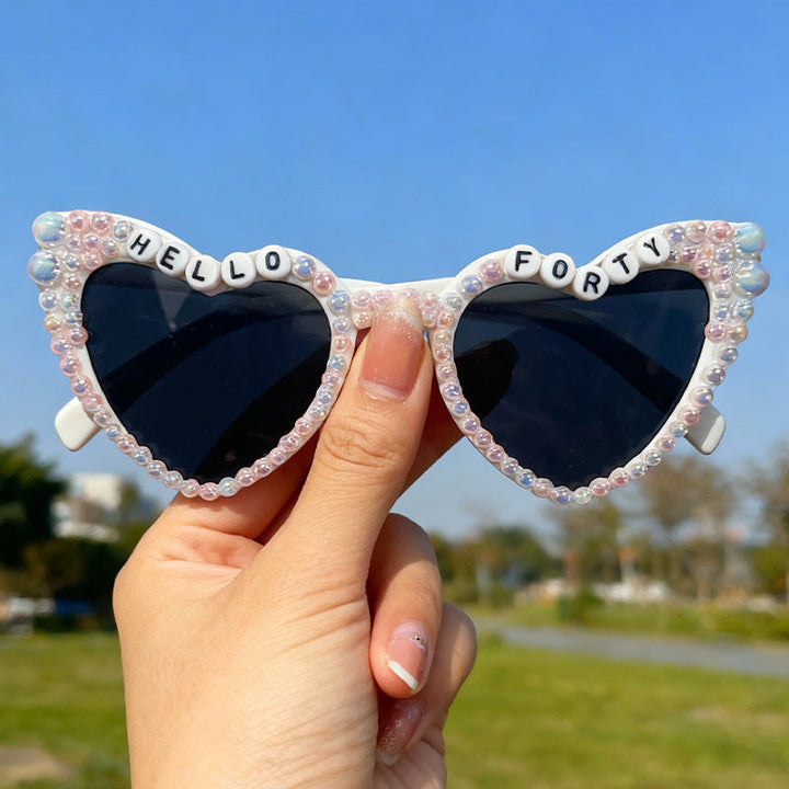 Stylish women's cat-eye sunglasses with unique pearl details, offering reliable UV protection.