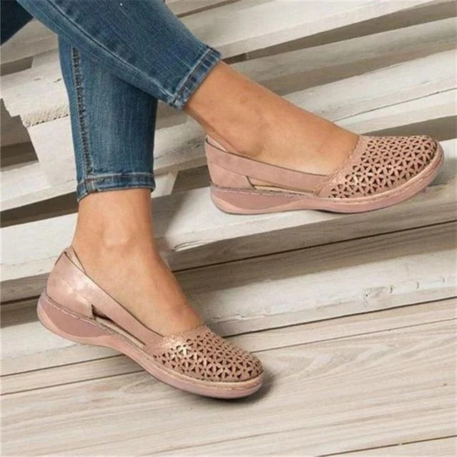 Stylish women's round toe wedge sandals with elegant perforations and modern side cutouts.