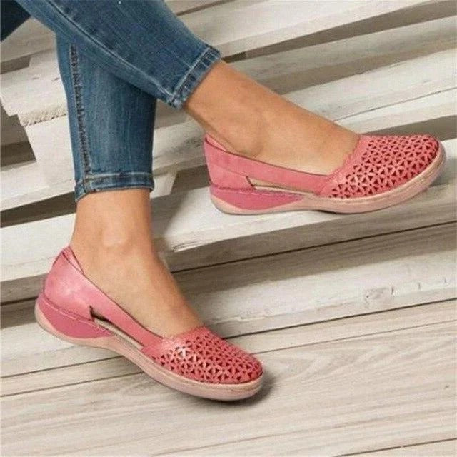 Trendy women's perforated wedge sandals with a comfortable round toe and fashionable cutout details.