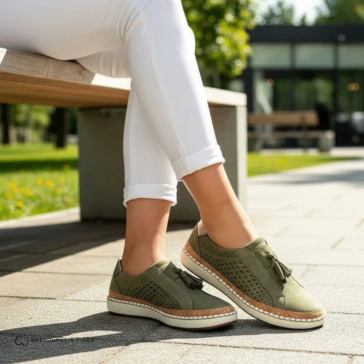 Casual women's perforated slip-on flats, perfect for summer. Comfortable vegan leather footwear with tassels.