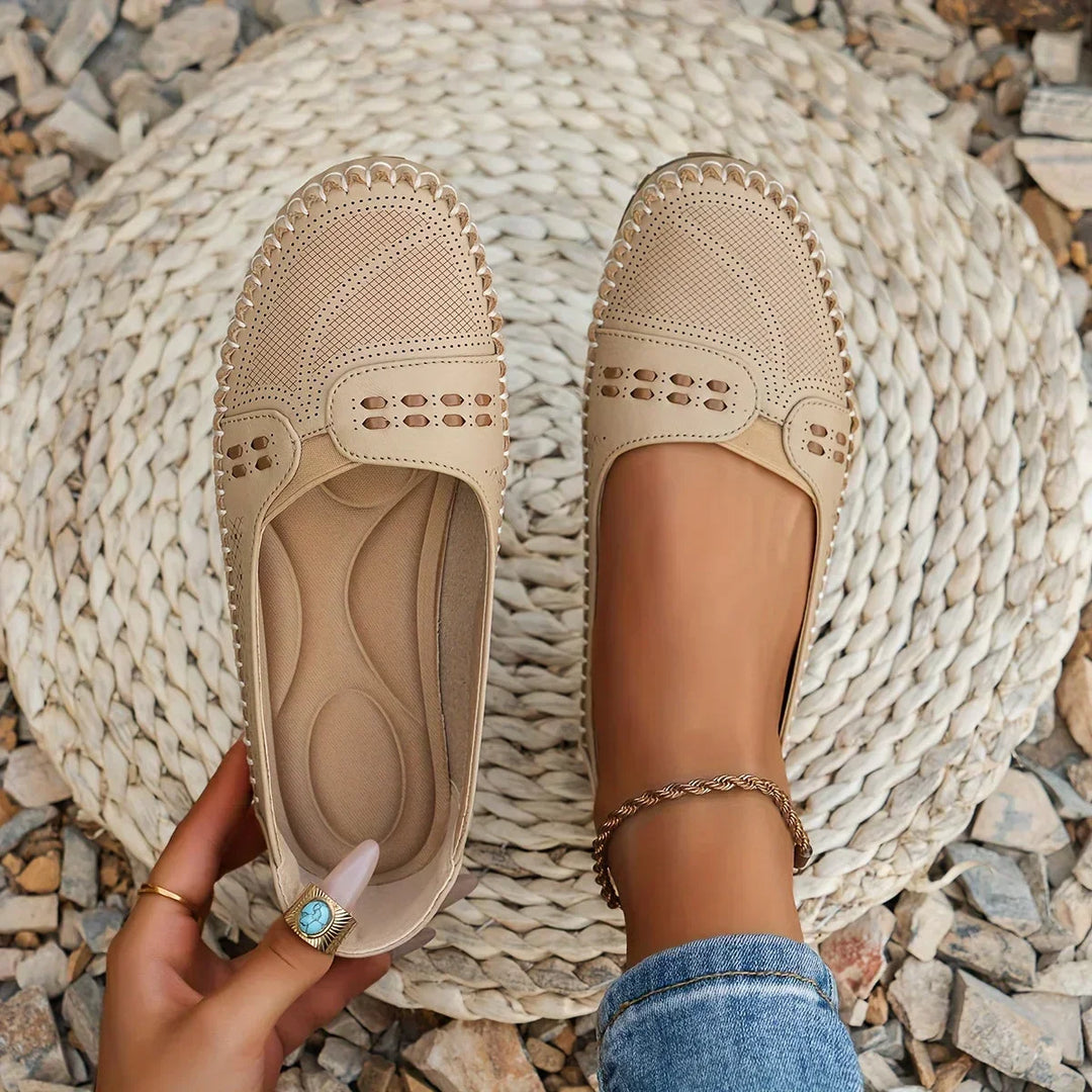 Women's perforated slip-on loafers, ideal for breathable summer comfort & casual everyday style.