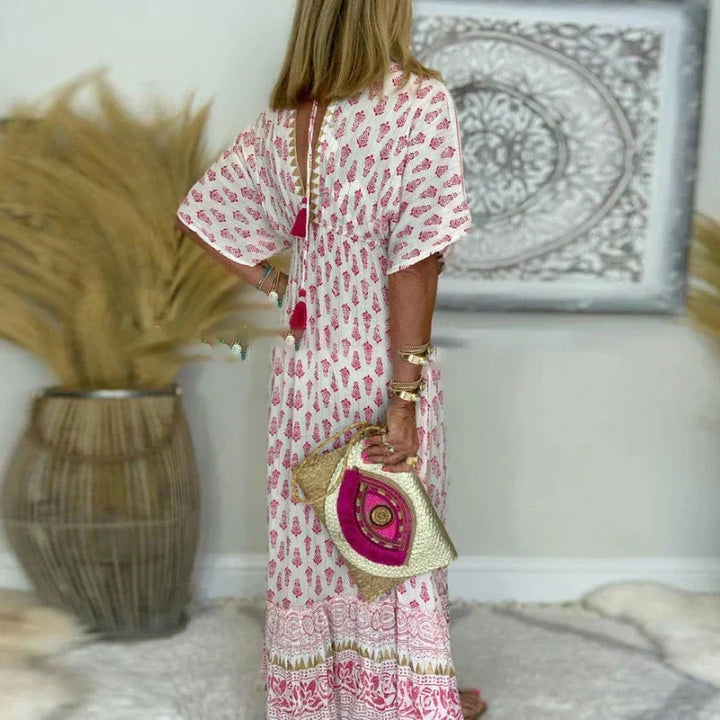 Relaxed fit women's boho print maxi dress in pink with a flattering V-neckline & comfortable short sleeves.
