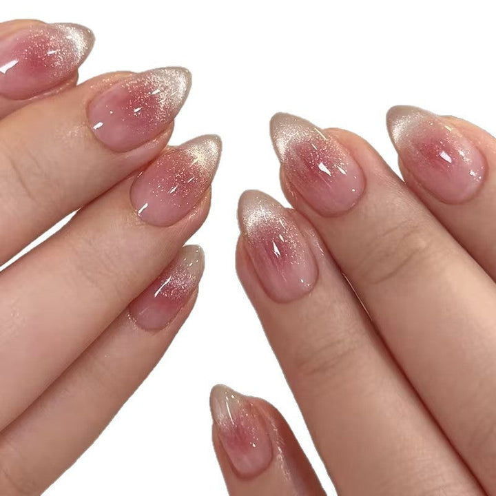 Reusable women's press-on nails with a glamorous pink glitter French tip for instant nail art.