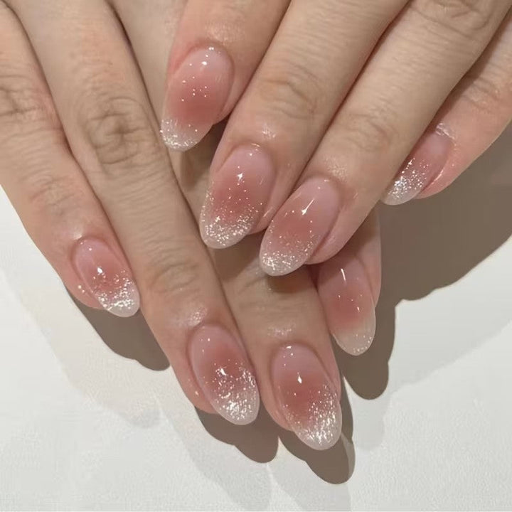 Easy-to-apply pink glitter French tip press-on nails, offering a beautiful, quick manicure solution.