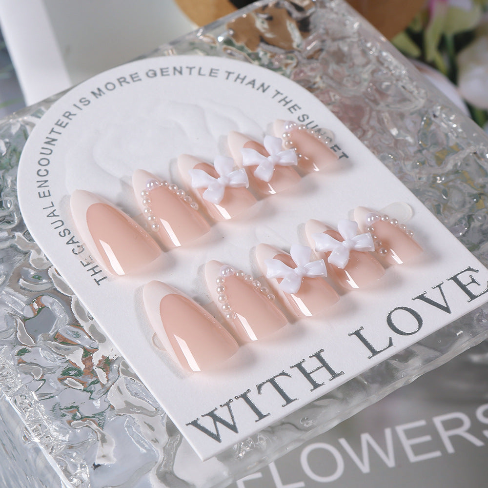 Elegant women's artificial nail tips featuring charming bow accents, perfect for an easy, salon-quality look.