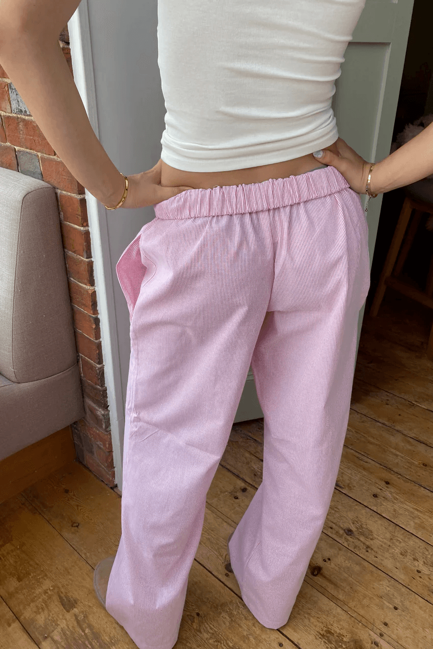 Lightweight women's lounge trousers with relaxed fit & elastic waist. Soft fabric, available in white, pink & green.