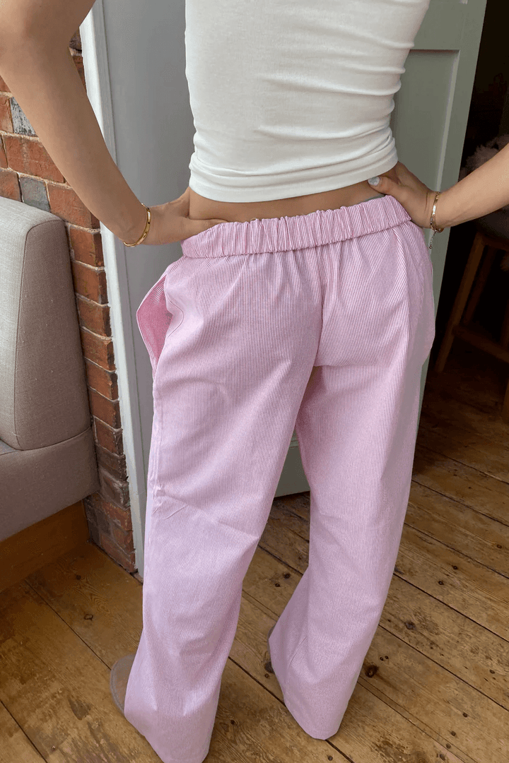 Lightweight women's lounge trousers with relaxed fit & elastic waist. Soft fabric, available in white, pink & green.