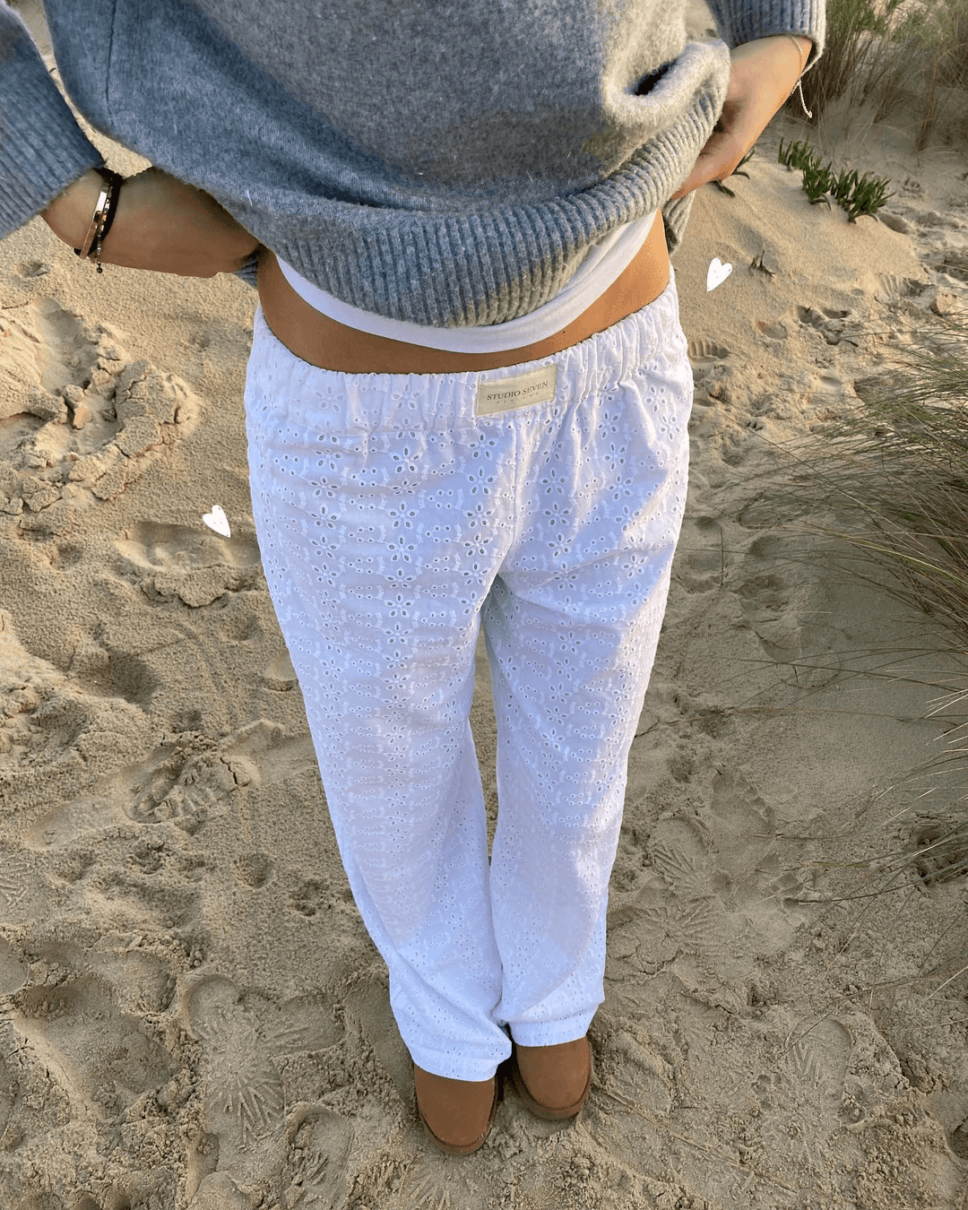 White women's lightweight lounge trousers. Soft fabric, relaxed fit, and elastic waist for ultimate comfort & casual wear.