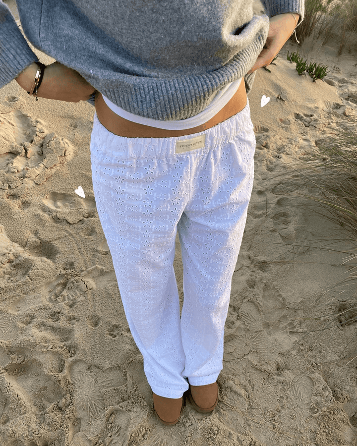 White women's lightweight lounge trousers. Soft fabric, relaxed fit, and elastic waist for ultimate comfort & casual wear.