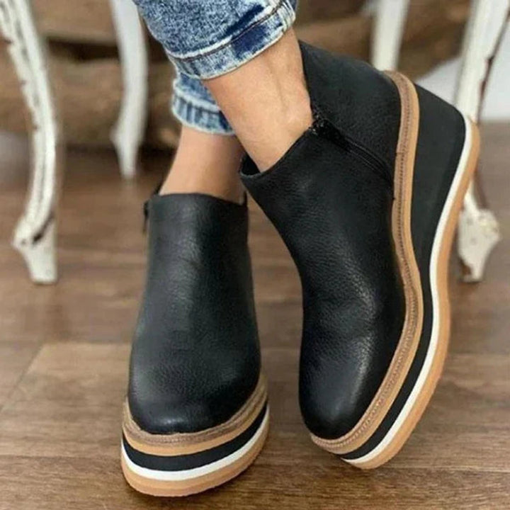 Stylish women's round-toe platform wedge ankle boots with a practical side zip, ideal for fashion-forward looks.