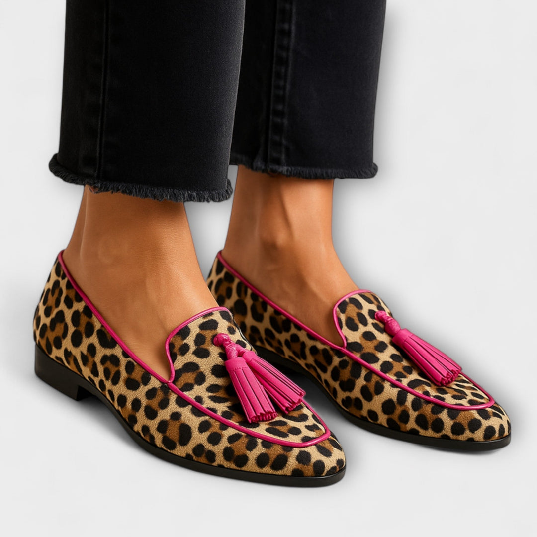Women's playful animal print loafers with tassel accent. Stylish slip-on casual footwear for everyday wear.