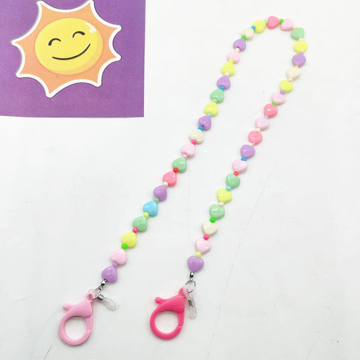 Close-up of playful heart and star pendant necklace, showcasing colorful design for women.