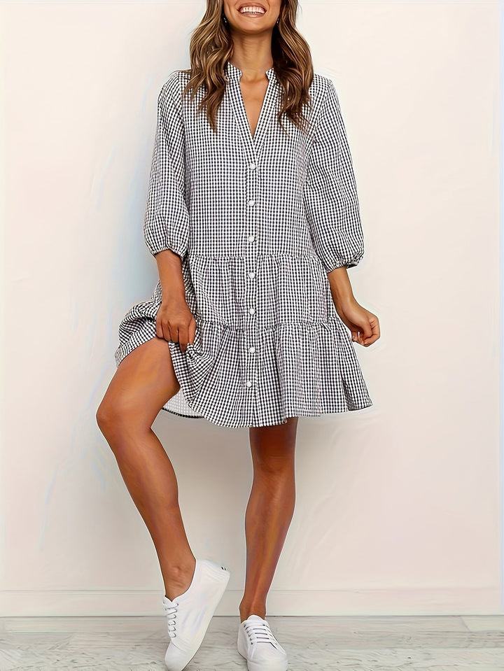 Gingham striped women's mini dress featuring playful puffed sleeves, ideal for a casual summer look.