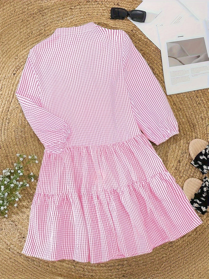 Playful striped summer mini dress for women, featuring charming puffed sleeves and a flattering tiered skirt.